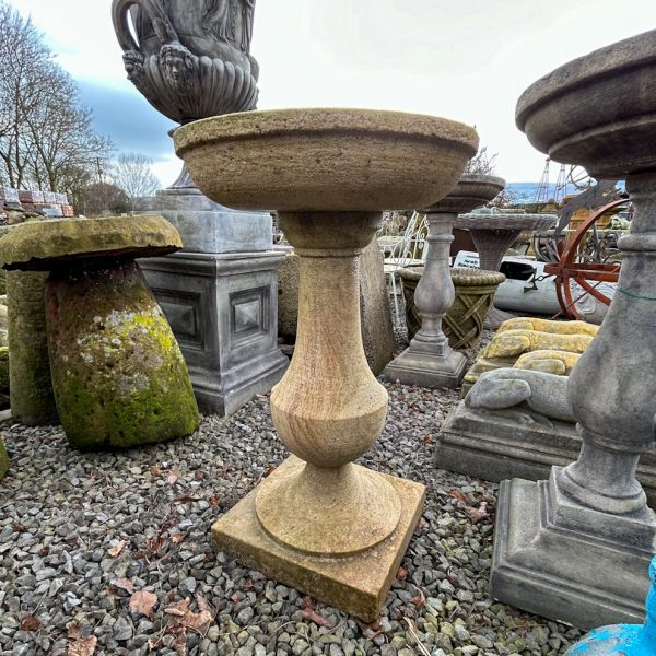 Carved stone birdbath